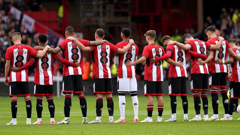 Sheffield United players wear shirts in memory of Sheffield United women's player Maddy Cusack, who died earlier this week, as they observe a minute's silence ahead of the Premier League match at Bramall Lane