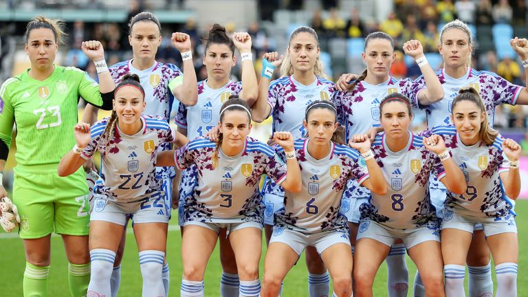 Spain players hold up their wrists to display a message that reads SeAcabo in protest prior to their Women's Nations League match against Sweden