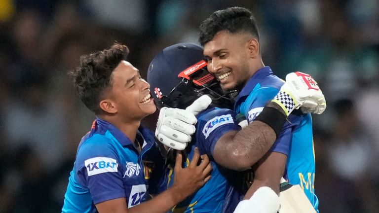 Sri Lanka's Charith Asalanka is embraced by Dunith Wellalage and Matheesha Pathirana as they celebrate their two-wicket win over Pakistan (Associated Press)
