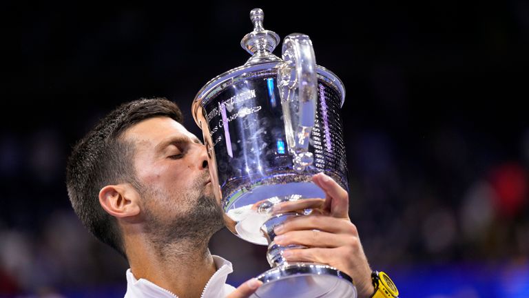 Novak Djokovic kisses the championship trophy after defeating Daniil Medvedev in the men&#39;s singles final of the US Open