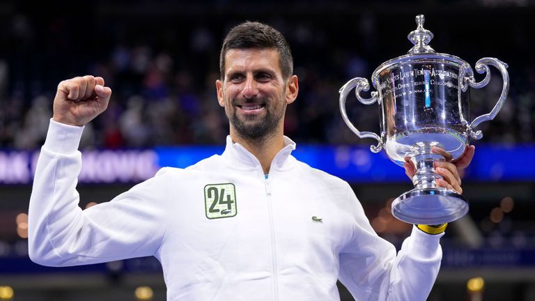 Novak Djokovic holds up the championship trophy after defeating Daniil Medvedev at the US Open in the men&#39;s singles final