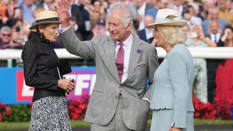 King Charles III waves to the Doncaster crowd before Desert Hero's run in the St Leger
