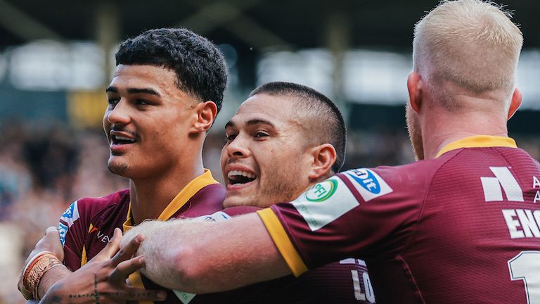Huddersfield’s Will Pryce celebrates with Tui Lolohea after scoring a try.
