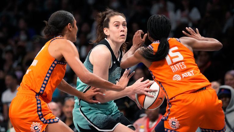 Connecticut Sun guard Tiffany Hayes (15) and forward Olivia Nelson-Ododa (10) guard New York Liberty forward Breanna Stewart, center, during the second half of Game 2 of a WNBA basketball playoffs semifinal Tuesday, Sept. 26, 2023, in New York.