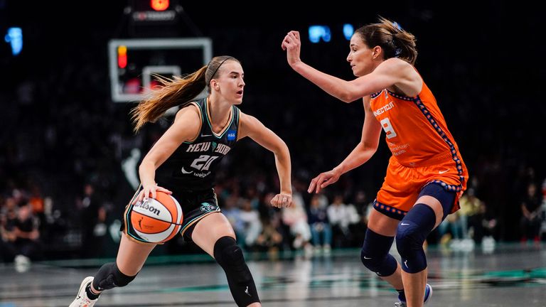 New York Liberty guard Sabrina Ionescu, left, dribbles against Connecticut Sun guard Rebecca Allen during the third quarter of a WNBA basketball game Sunday, Sept. 24, 2023, in New York.