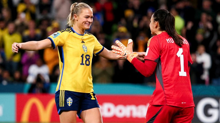 Fridolina Rolf congratulates Zecira Musovic after Sweden beat the USA on penalties