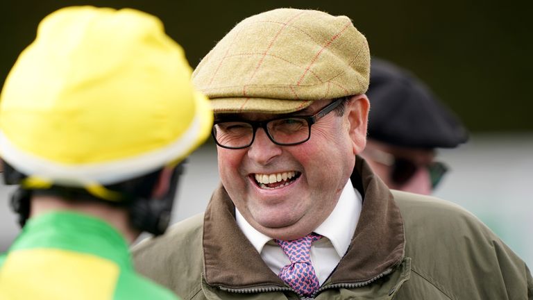 Alan King jokes with a jockey ahead of a race at Nottingham