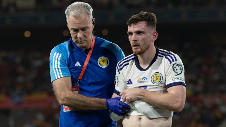 Andy Robertson leaves the field with an injury during Scotland&#39;s game against Spain