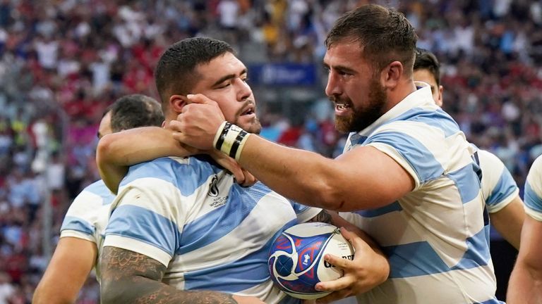 Argentina's Joel Sclavi, left, is congratulated after scoring a try to tie 17-17 during the Rugby World Cup quarterfinal match between Wales and Argentina at the Stade de Marseille in Marseille, France, Saturday, Oct. 14, 2023. (AP Photo/Lewis Joly)