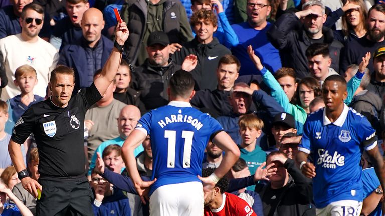 Everton's s Ashley Young is shown a red card by referee Craig Pawson during the Premier League match vs Liverpool
