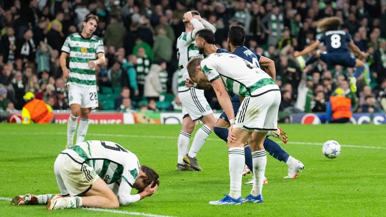 Celtic players fall to the floor dejected after Lazio's late winner