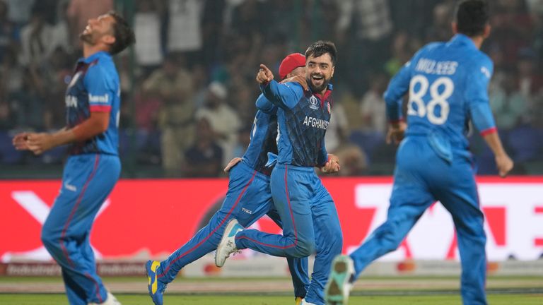 Afghanistan&#39;s Rashid Khan celebrates after dismissing England&#39;s Adil Rashid