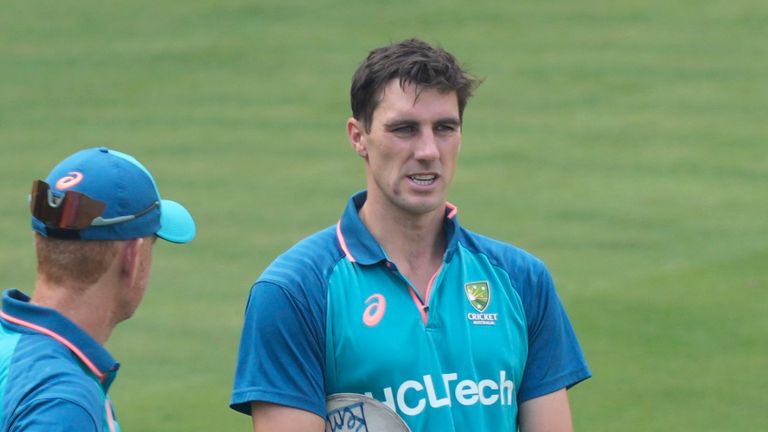 Australia's captain Pat Cummins talks to coach Andrew McDonald ahead of their match against Pakistan in Bengaluru