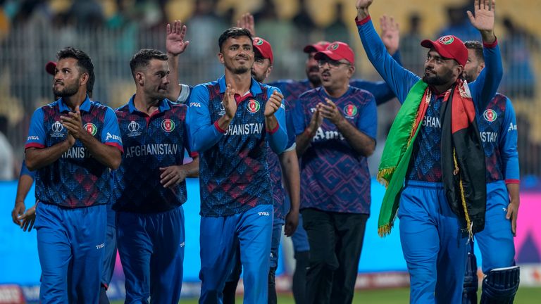 Afghanistan's players acknowledge the crowd after winning their match against Pakistan