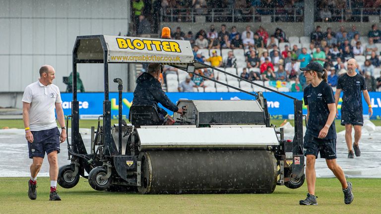 Groundstaff at Headingley helping to put the covers on during a rain interruption 