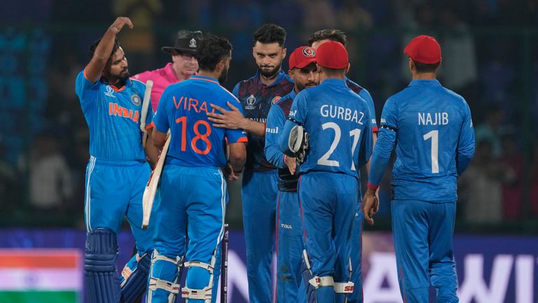 India's Virat Kohli and Shreyas Iyer shake hands with Afghanistan players following their eight wickets win in the ICC Men's Cricket World Cup 