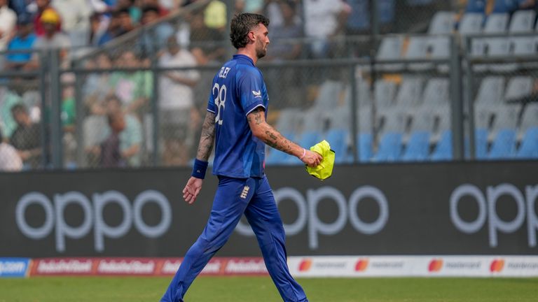 England's Reece Topley walks off the field after sustaining an injury in the seventh match against South Africa in Mumbai