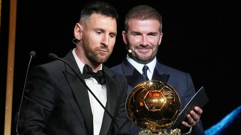 Inter Miami team co-owner and former soccer star David Beckham, right, smiles as Inter Miami's and Argentina's national team player Lionel Messi receives the 2023 Ballon d'Or trophy from during the 67th Ballon d'Or (Golden Ball) award ceremony at Theatre du Chatelet in Paris, France, Monday, Oct. 30, 2023. (AP Photo/Michel Euler)