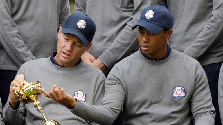 USA's Tiger Woods looks at the trophy with captain Davis Love III in the 2012 edition of the Ryder Cup. Could do the golfing legend return for another stint?