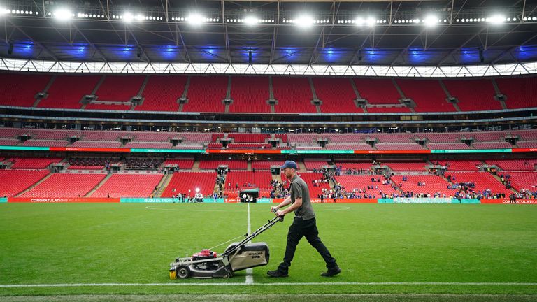Groundstaff at Wembley help prepare the pitch before kick-off