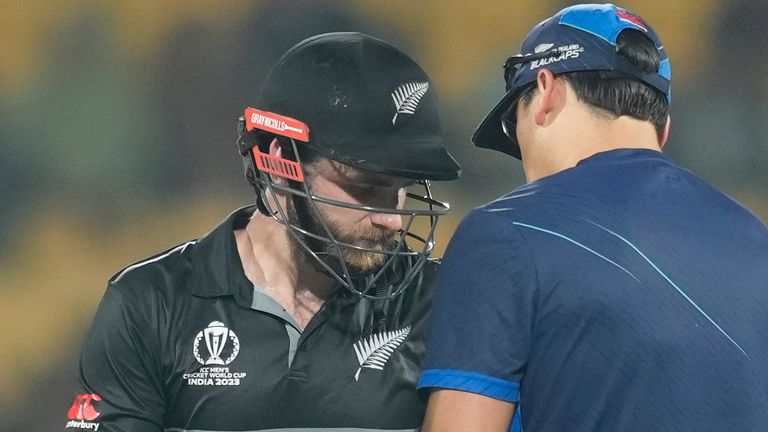 New Zealand's captain Kane Williamson , left, receive first-aid after a ball hit his thumb during the ICC Men's Cricket World Cup match between New Zealand and Bangladesh in Chennai , India, Friday, Oct. 13, 2023. (AP Photo/Eranga Jayawardena)