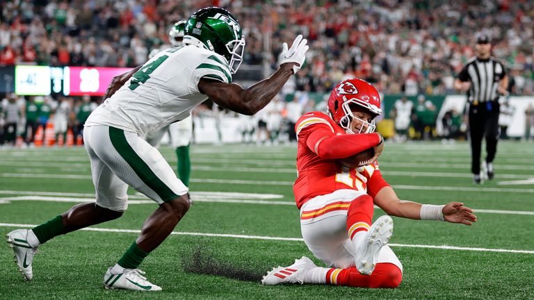 Kansas City Chiefs quarterback Patrick Mahomes (15) slides inside the five yard line ahead of New York Jets cornerback D.J. Reed (4) for a first down during the fourth quarter of an NFL football game, Sunday, Oct. 1, 2023, in East Rutherford, N.J.