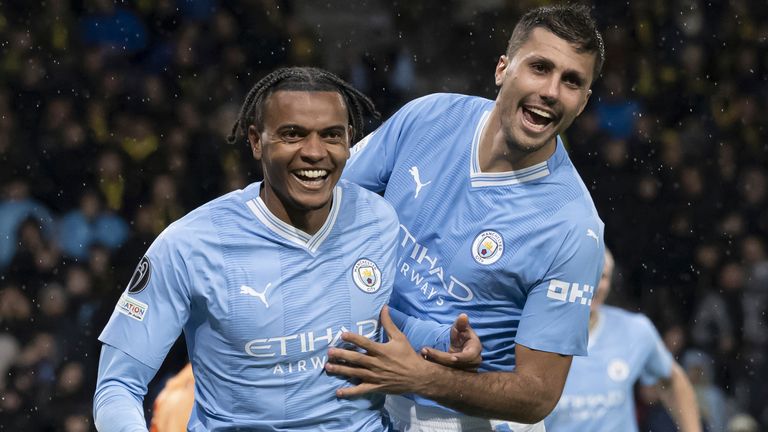 Manchester City's Manuel Akanji, left, celebrates scoring a goal with team-mate Rodri vs Young Boys