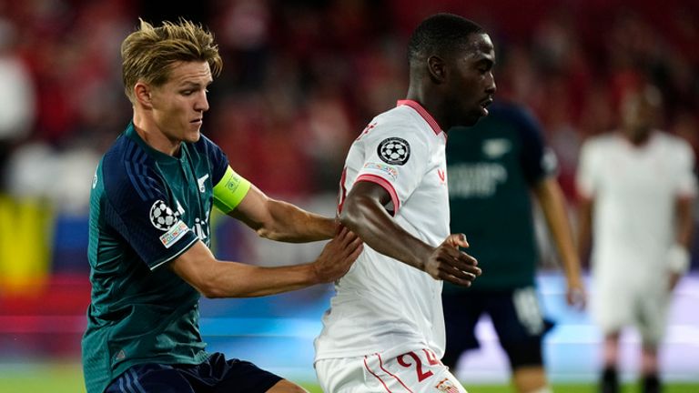 Arsenal's Martin Odegaard, left, challenges Sevilla's Boubakary Soumare during the Champions League Group B soccer match between Sevilla and Arsenal at the Ramon Sanchez-Pizjuan stadium in Seville, Spain, Tuesday Oct. 24, 2023. (AP Photo/Jose Breton)