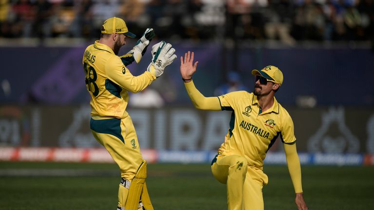 Australian Josh Inglis (left) and Mitchell Starc celebrate the dismissal of New Zealand's Devon Conway during the ICC Men's Cricket World Cup match between Australia and New Zealand in Dharamshala, India, Saturday October 28, 2023. (AP Photo/ Ashwini Bhatia)