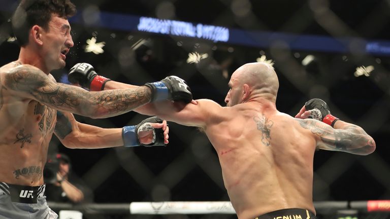 Alexander Volkanovski drops Max Holloway in their five-round featherweight title bout during UFC 276 