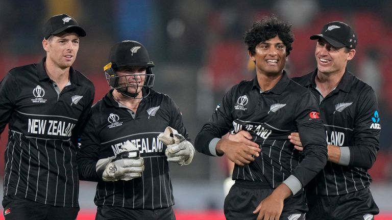 New Zealand's Rachin Ravindra, second right, is congratulated by his teammates as he took the wicket of Netherlands' Bas De Leede 