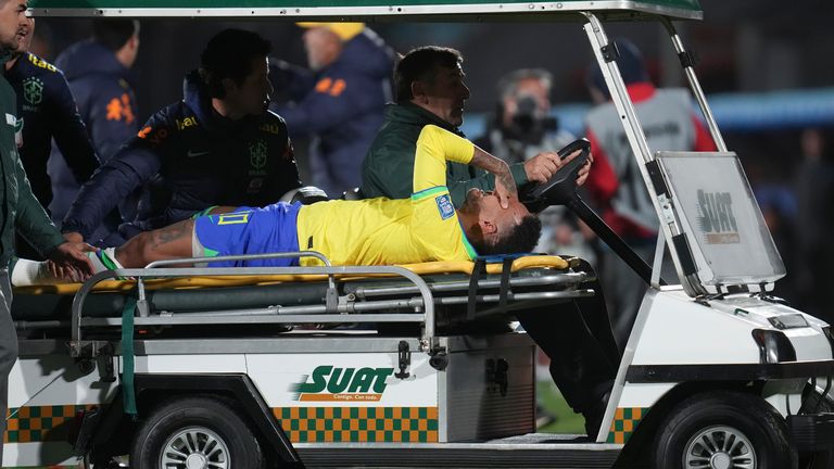 Brazil's Neymar is carried off the pitch on a stretcher after being injured during a qualifying soccer match for the FIFA World Cup 2026 against Uruguay at Centenario stadium in Montevideo, Uruguay, Tuesday, Oct. 17, 2023. (AP Photo/Matilde Campodonico)