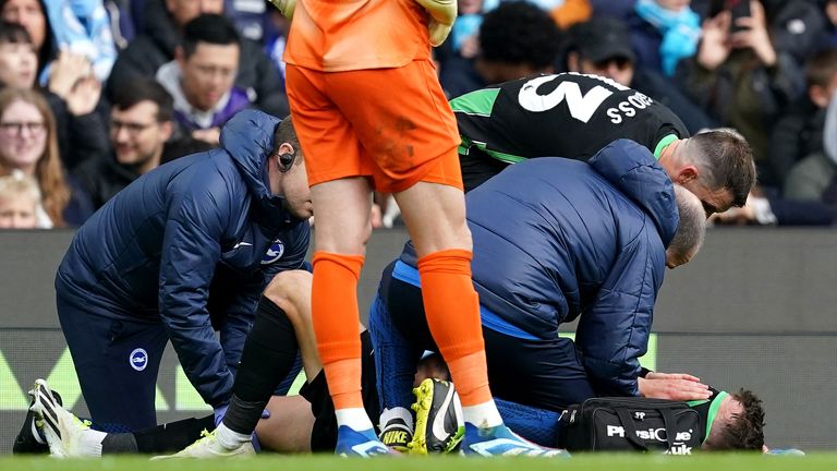 Brighton's Solly March receives medical treatment after picking up and injury