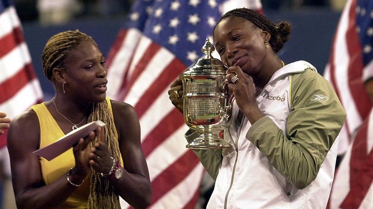 Venus Williams of the US (R) holds the champion&#39;s trophy beside her runner-up sister Serena during the women&#39;s finals ceremonies at the US Open in Flushing Meadows, New York, 08 September 2001. Venus Williams won the US Open final with a 6-2, 6-4 victory over younger sister Serena in the first Grand Slam final between blacks and the first between sisters in 117 years.