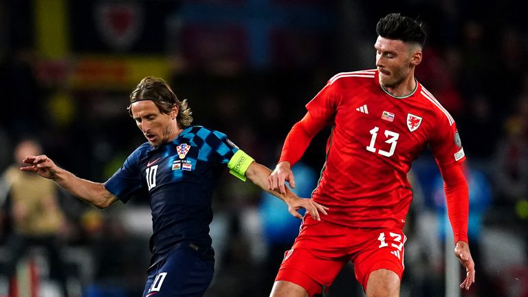 Luka Modric protects the ball from Kieffer Moore