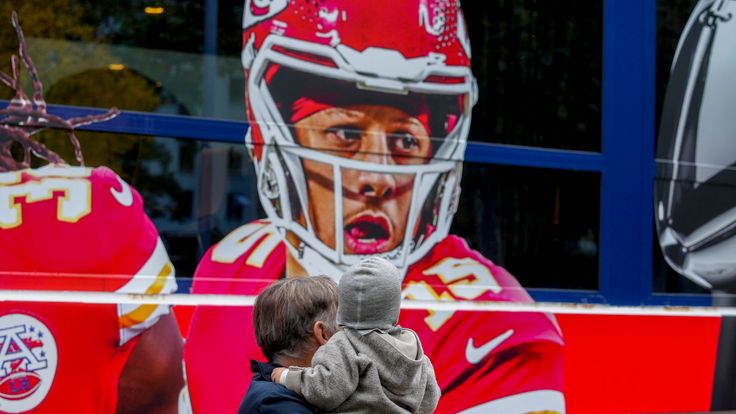 People look at a ship with the picture of Kansas City Chiefs quarterback Patrick Mahomes, 
