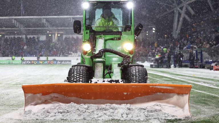 HELSINKI, FINLAND - NOVEMBER 30: A tractor clears snow off the pitch during a delay in the second half during a UEFA Conference League group stage match between HJK Helsinki and Aberdeen at the Bolt Arena, on November 30, 2023, in Helsinki, Finland. (Photo by Ross MacDonald / SNS Group)