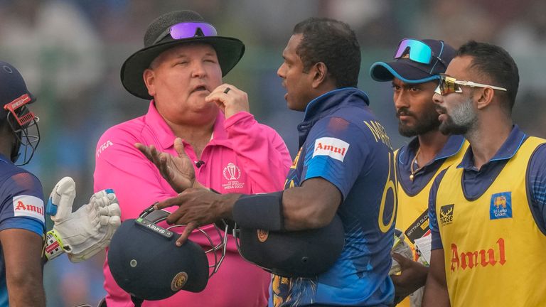 Sri Lanka's Angelo Mathews, third right, talks to umpires after he was declared timed out during the ICC Men's Cricket World Cup match between Bangladesh and Sri Lanka in New Delhi, India, Monday, Nov. 6, 2023. Mathews who wasn...t ready to face his first ball within the stipulated two minutes became the first batter to be timed out in international cricket as the strap of his helmet appeared to be broken and he called for a replacement helmet. (AP Photo/Manish Swarup)