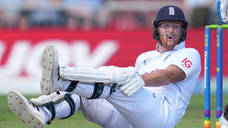 England&#39;s captain Ben Stokes, bottom, in pain after hurting his left knee during the second day of the 2nd test cricket match between England and South Africa at the Old Trafford, in Manchester, England, Friday, Aug. 26, 2022. (AP Photo/Jon Super)