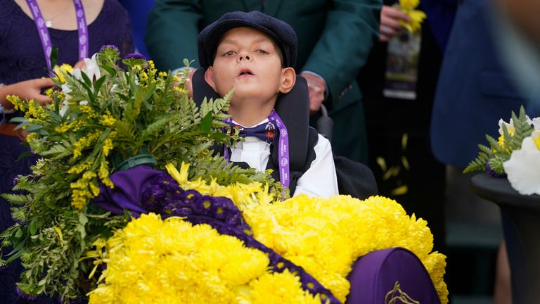Cody Dorman wears the winner's flower sash after Cody's Wish's success in the Breeders' Cup Dirt Mile