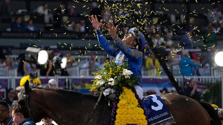 Junior Alvarado celebrates atop Cody&#39;s Wish after winning the Breeders&#39; Cup Dirt Mile at Santa Anita