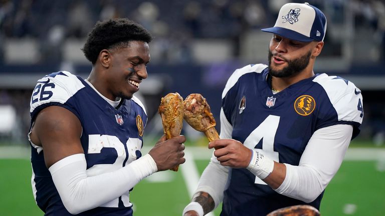 DaRon Bland and Dak Prescott celebrate by eating Thanksgiving turkey after the Cowboys defeated the Commanders