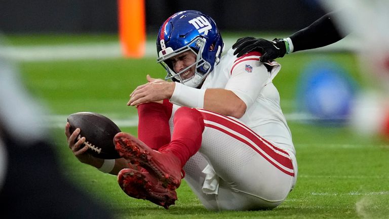 New York Giants quarterback Daniel Jones grimaces after a sack during the first half of an NFL football game against the Las Vegas Raiders, Sunday, Nov. 5, 2023, in Las Vegas. (AP Photo/John Locher)