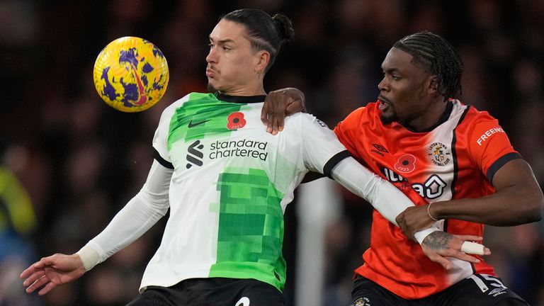 Liverpool's Darwin Nunez, left, challenges for the ball with Luton Town's Teden Mengi