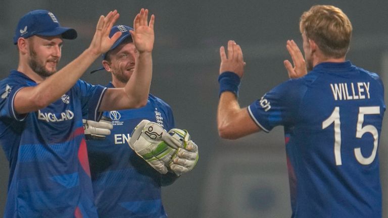 England's David Willey, right, celebrates with teammates after the dismissal of Pakistan's Agha Salman during the ICC Men's Cricket World Cup match between Pakistan and England in Kolkata, India, Saturday, Nov. 11, 2023. (AP Photo/Altaf Qadri)