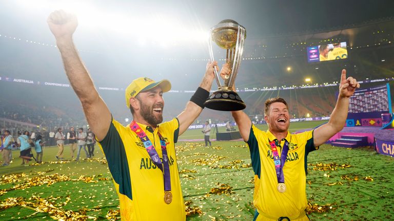 Australia&#39;s Glenn Maxwell holds the trophy with teammate David Warner after Australia beat India in the Cricket World Cup final