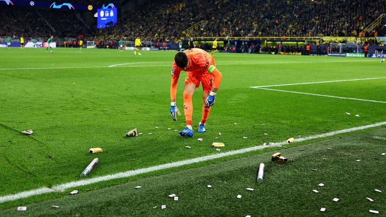 Gregor Kobel of Borussia Dortmund looks on as fake money is seen on the pitch during the UEFA Champions League match between Borussia Dortmund and Newcastle United at Signal Iduna Park on November 07, 2023 in Dortmund, Germany