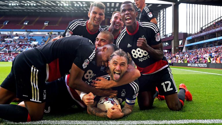 Lansbury is mobbed by Forest team-mates after scoring against Aston Villa in September 2016