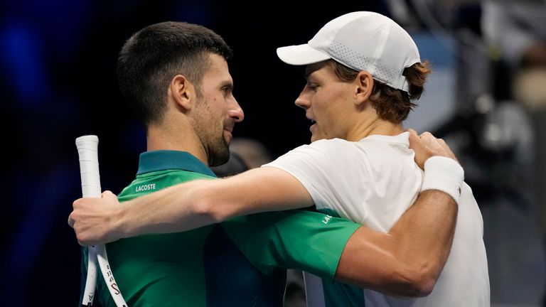Italy's Jannik Sinner, right, embraces Serbia's Novak Djokovic at the end of the match