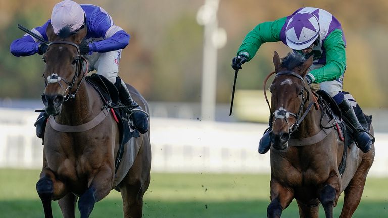 Jonathan Burke riding Beat The Bat (R, green sleeves) clear the last to win The Ascot Partners 'National Hunt' Maiden Hurdle at Ascot ahead of Welcom To Cartries (left)